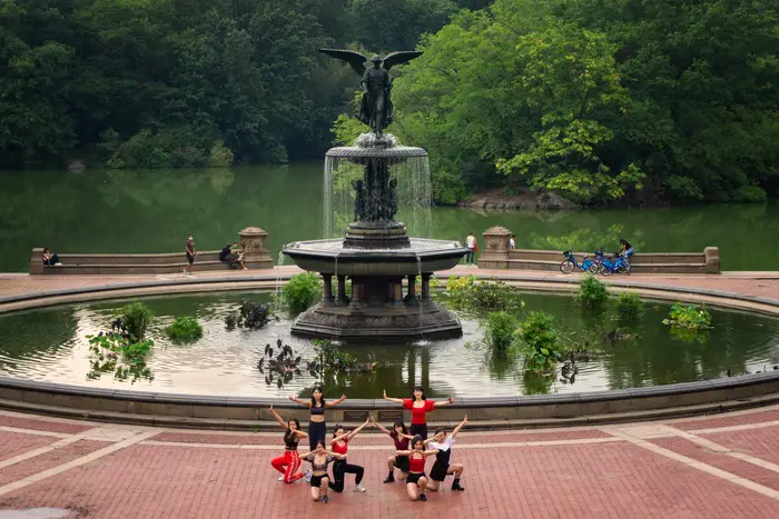 A photo of gymnasts posing in Central Park